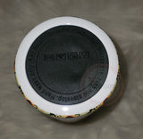 Silicone/rubber tumbler bottom with adhesive backing.